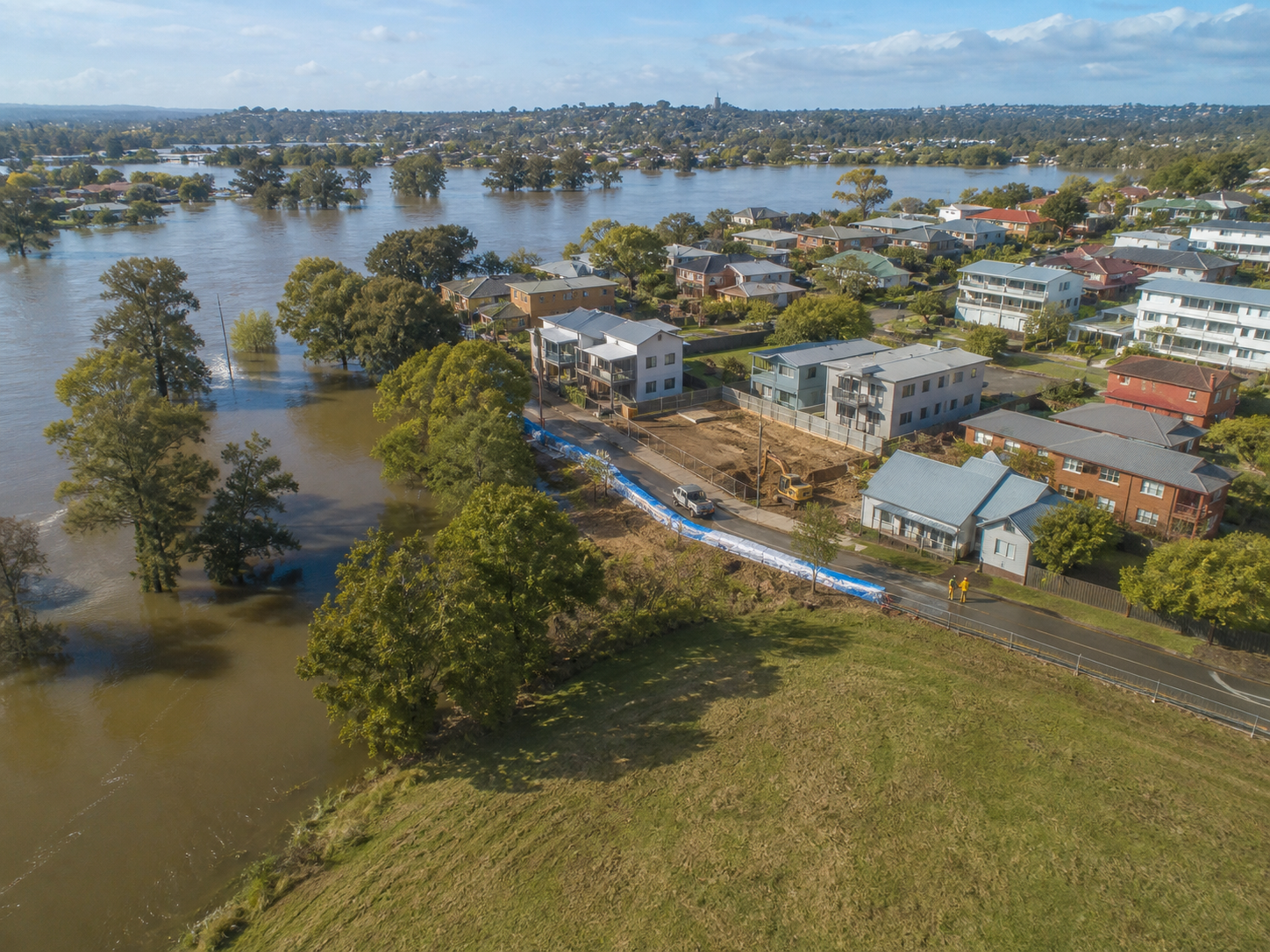 Australian residential street affected by flooding with water on the road
