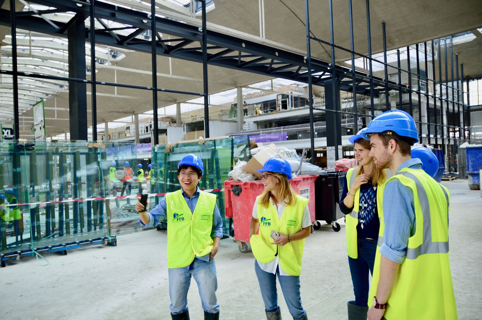 Construction specialists discussing project plans on an active building site