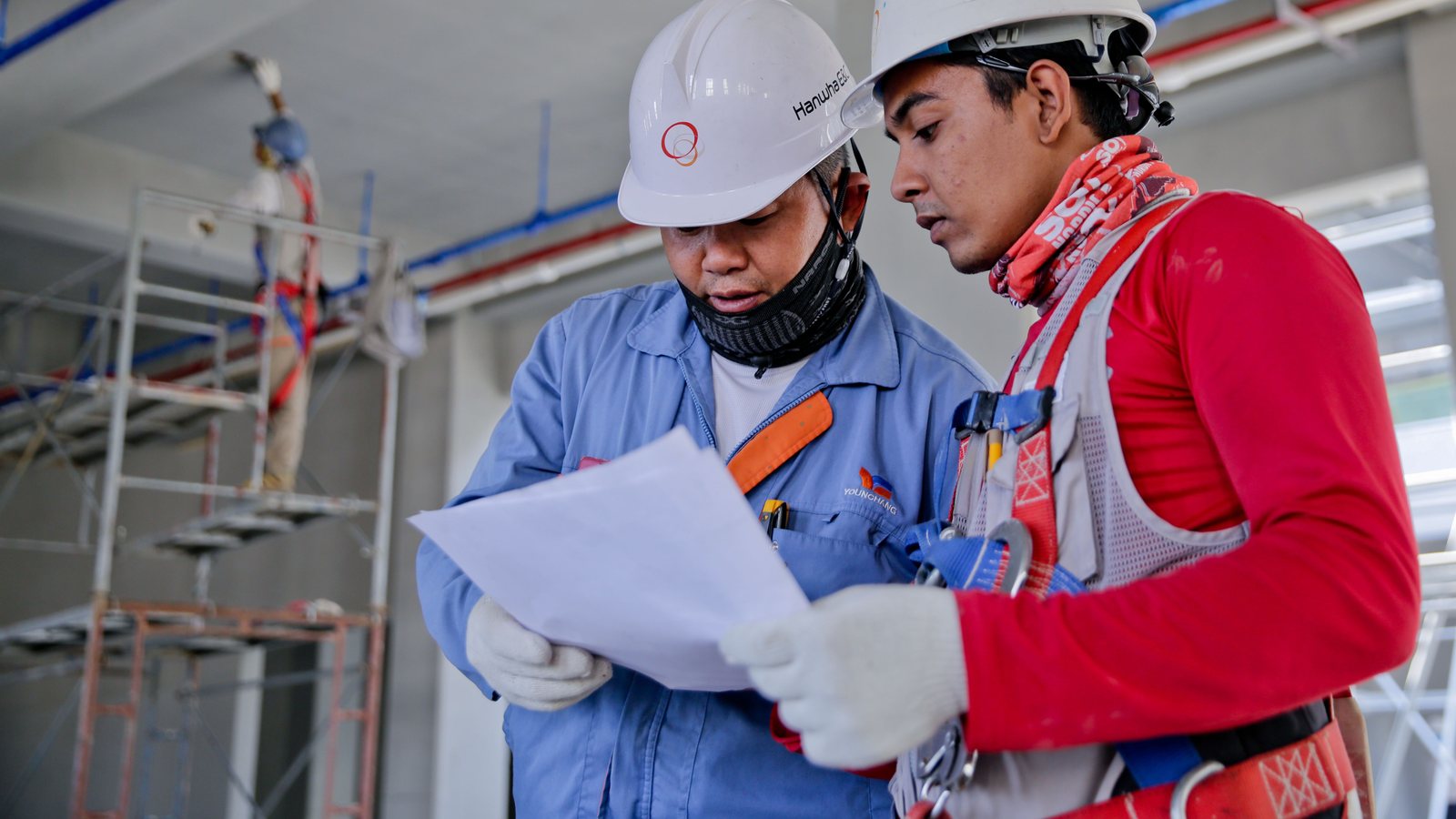Builder and developer reviewing construction plans on site