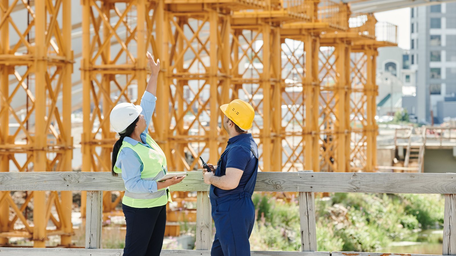 Construction team reviewing project risks and insurance responsibilities before site work