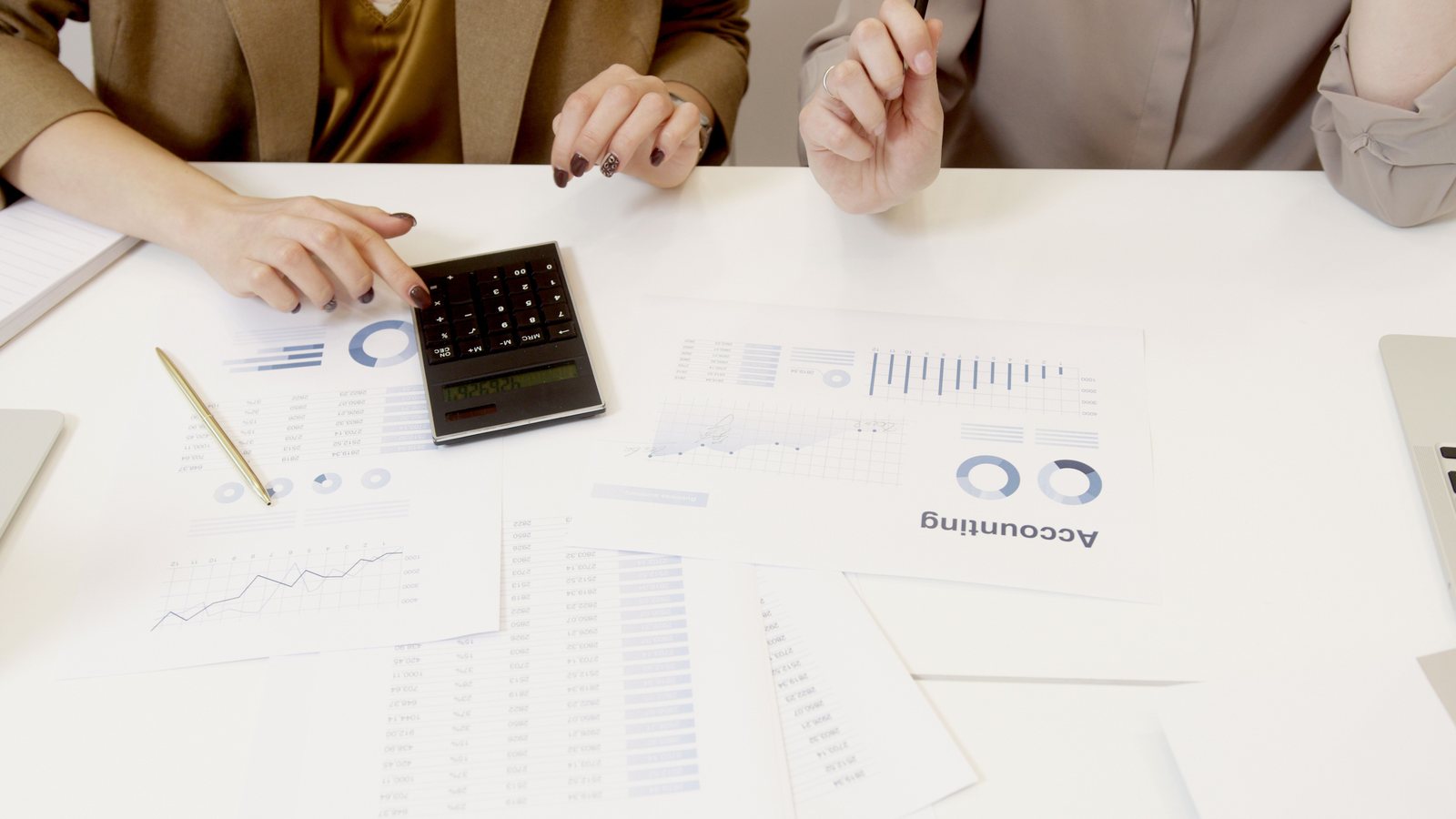 Joint venture partners reviewing fees and agreement terms