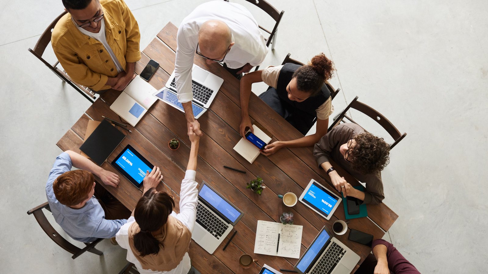 Independent property development reviewers challenging a project proposal around a table