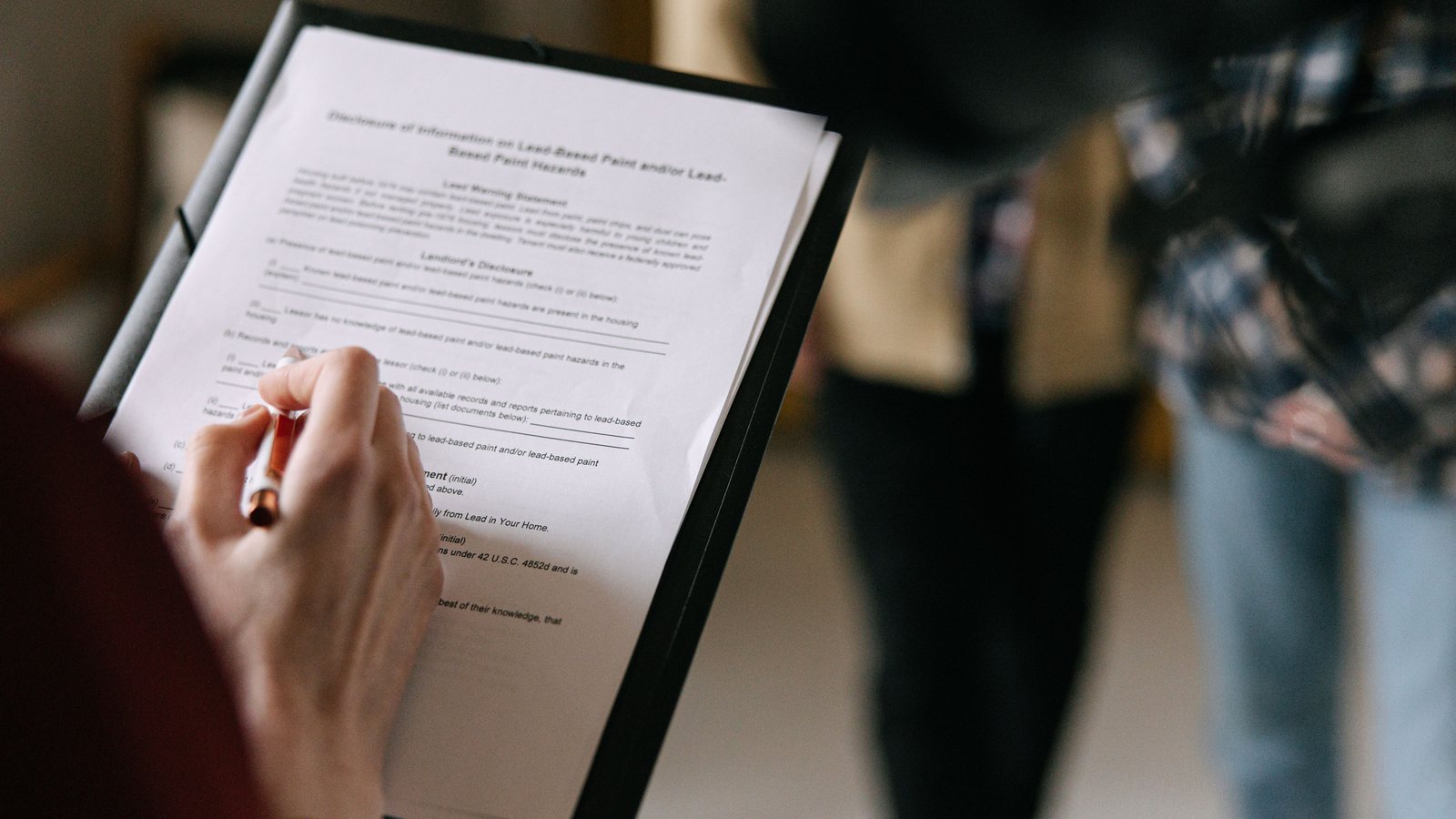 Property buyer and vendor representatives comparing offer documents
