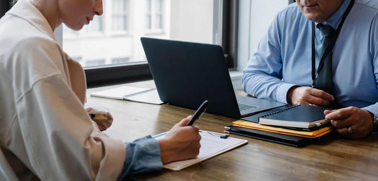 Property professionals discussing documents at a desk